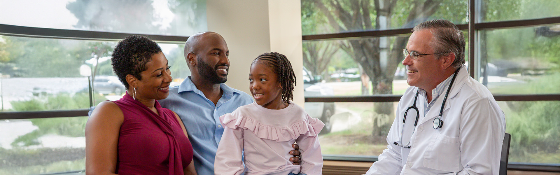Doctor speaking with parent and child