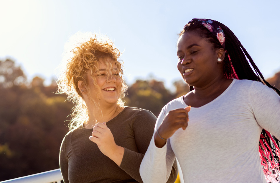 Two women jogging outdoors together