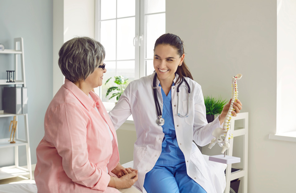 Spine specialist explaining spinal anatomy to patient