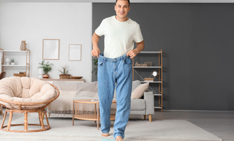 Man wearing loose jeans after weight loss