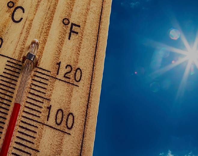 Thermometer showing high temperature in sun